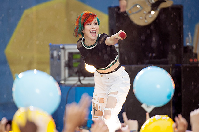 Hayley Williams of Paramore performing live, alt text: Hayley Williams of Paramore, energetic pop-punk icon, engages the crowd during a vibrant concert performance.