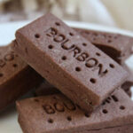 Image link to Bourbon biscuit recipe, featuring a stack of homemade bourbon biscuits, a British classic