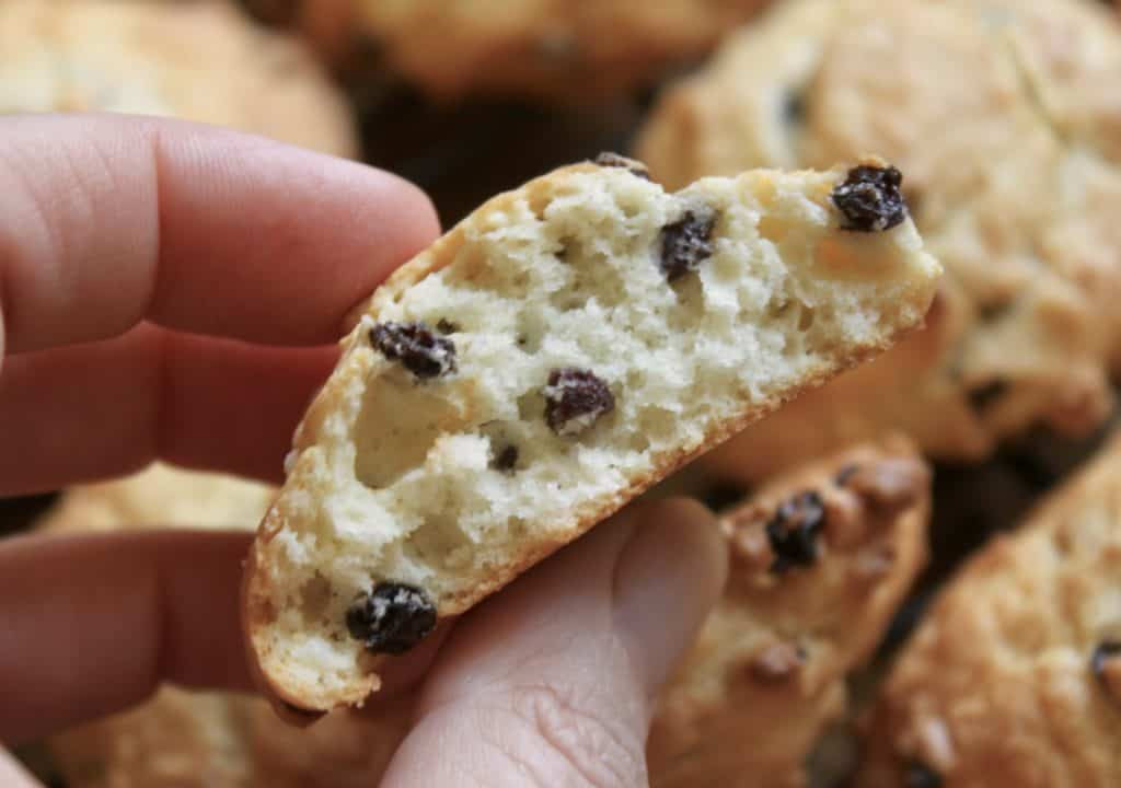 Inside view of a rock cake or rock bun, revealing its soft, crumbly texture with currants dispersed throughout