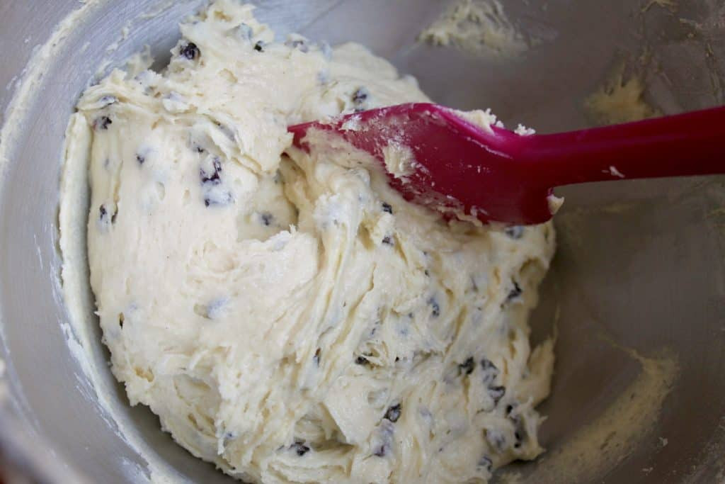 Mixing the rock cake dough in a bowl, emphasizing the minimal mixing required for a tender texture