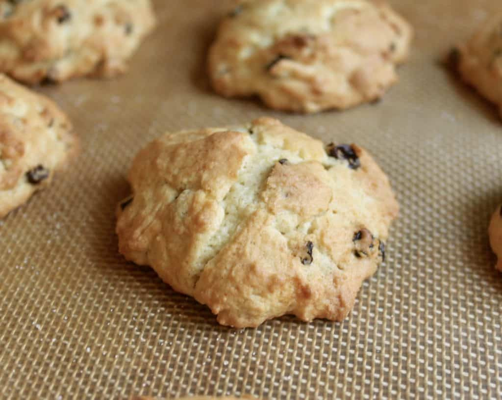 Baked rock cakes or rock buns on a baking tray, showing their golden brown color and slightly cracked tops