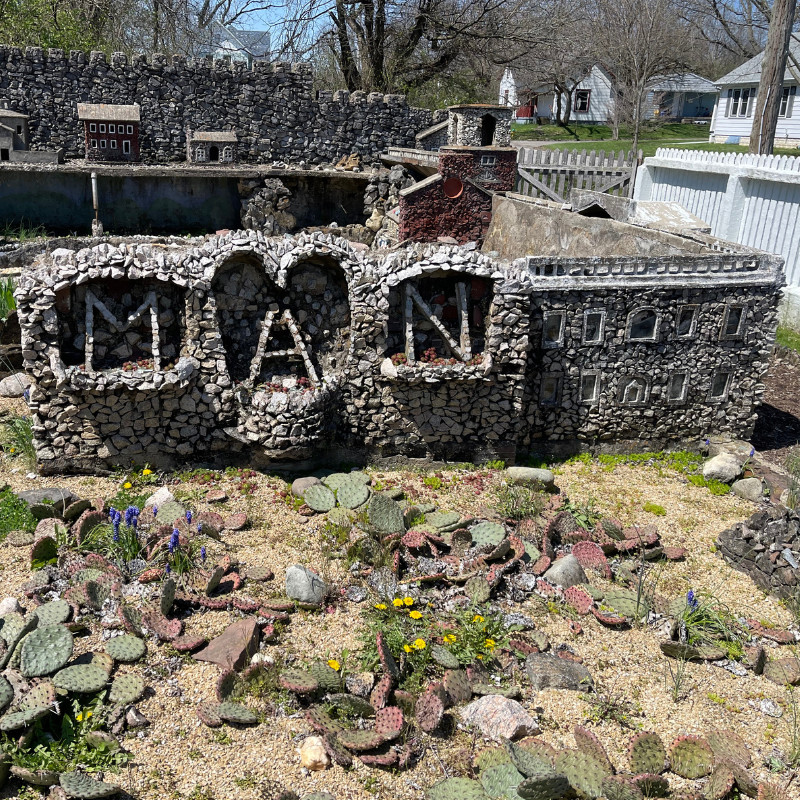 Intricate details of a sculpture in Hartman Rock Garden, demonstrating the use of diverse materials like stone, metal, and glass.