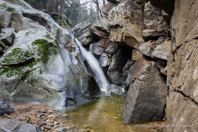 Base of Heart Rock Waterfall with wading hikers exploring the area