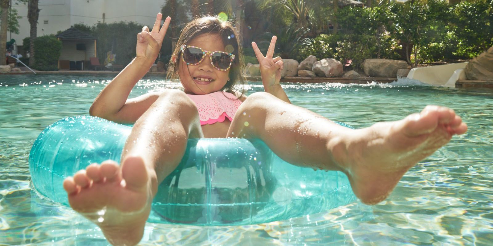 Guests enjoying water activities at the pool of Hard Rock Hotel Vallarta, Mexico, with all-inclusive access to water sports.