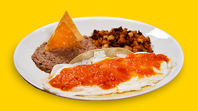 Flavorful ranchero eggs breakfast plate at Taco Palenque Round Rock, featuring fried eggs, tortillas, and salsa ranchera.