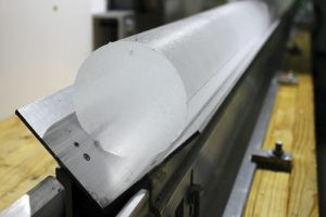 An ice core sample being examined in a lab, showcasing the layers of ice that provide historical climate data.