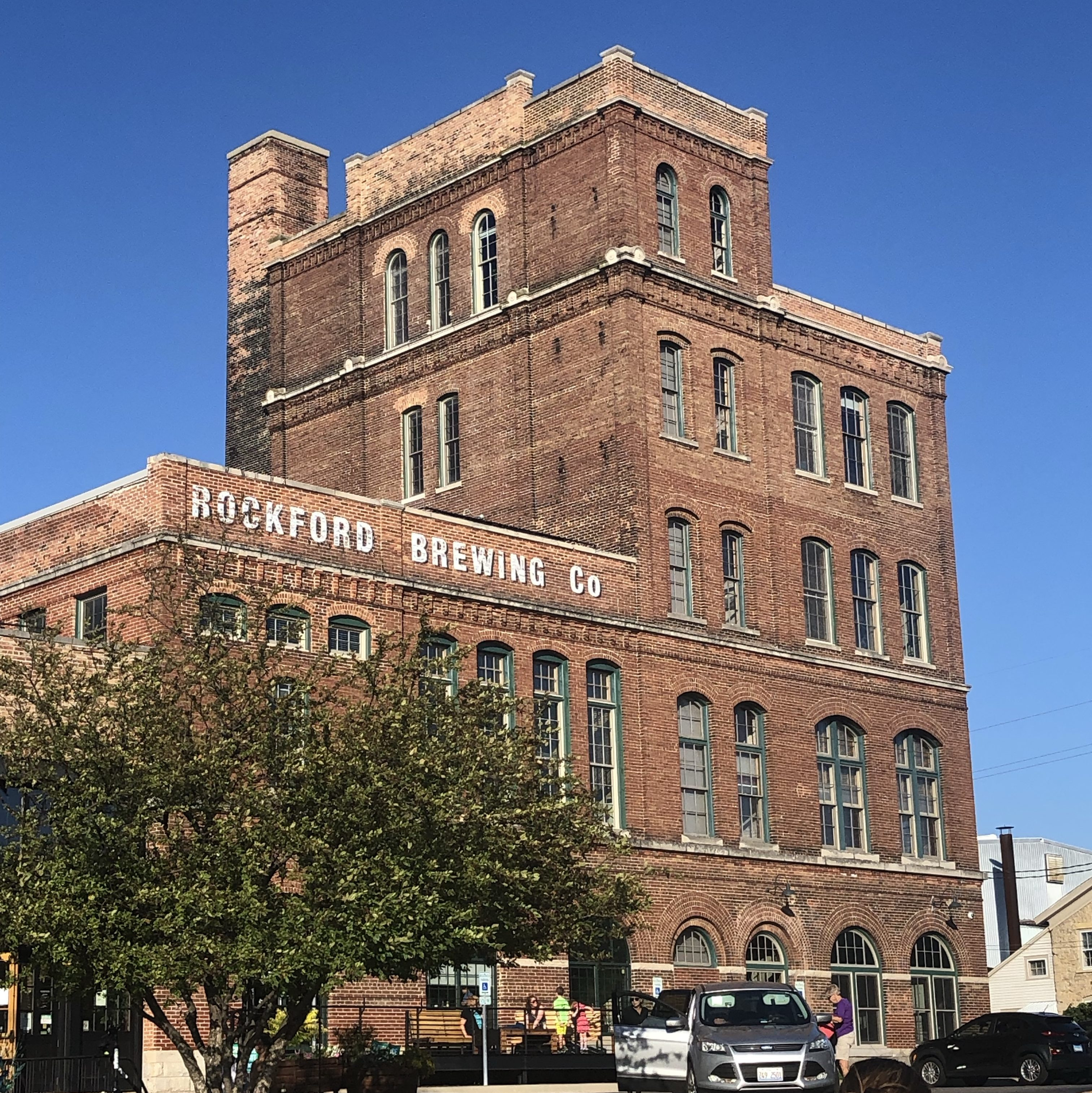 Exterior of Prairie Street Brewing in Rockford, IL, a large brick building on the Rock River