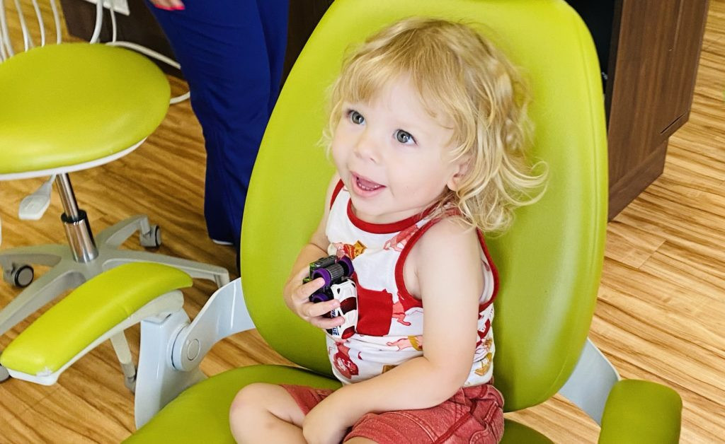 Dr. Jonathan Mitchell, a board-certified pediatric dentist at Rock Hill Pediatrics, warmly greets a young patient, ensuring a comfortable and friendly dental experience.