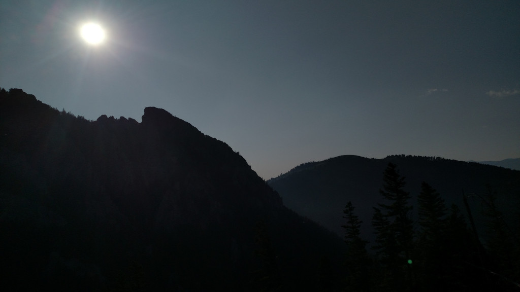 Frog Rock silhouetted against the bright sun.