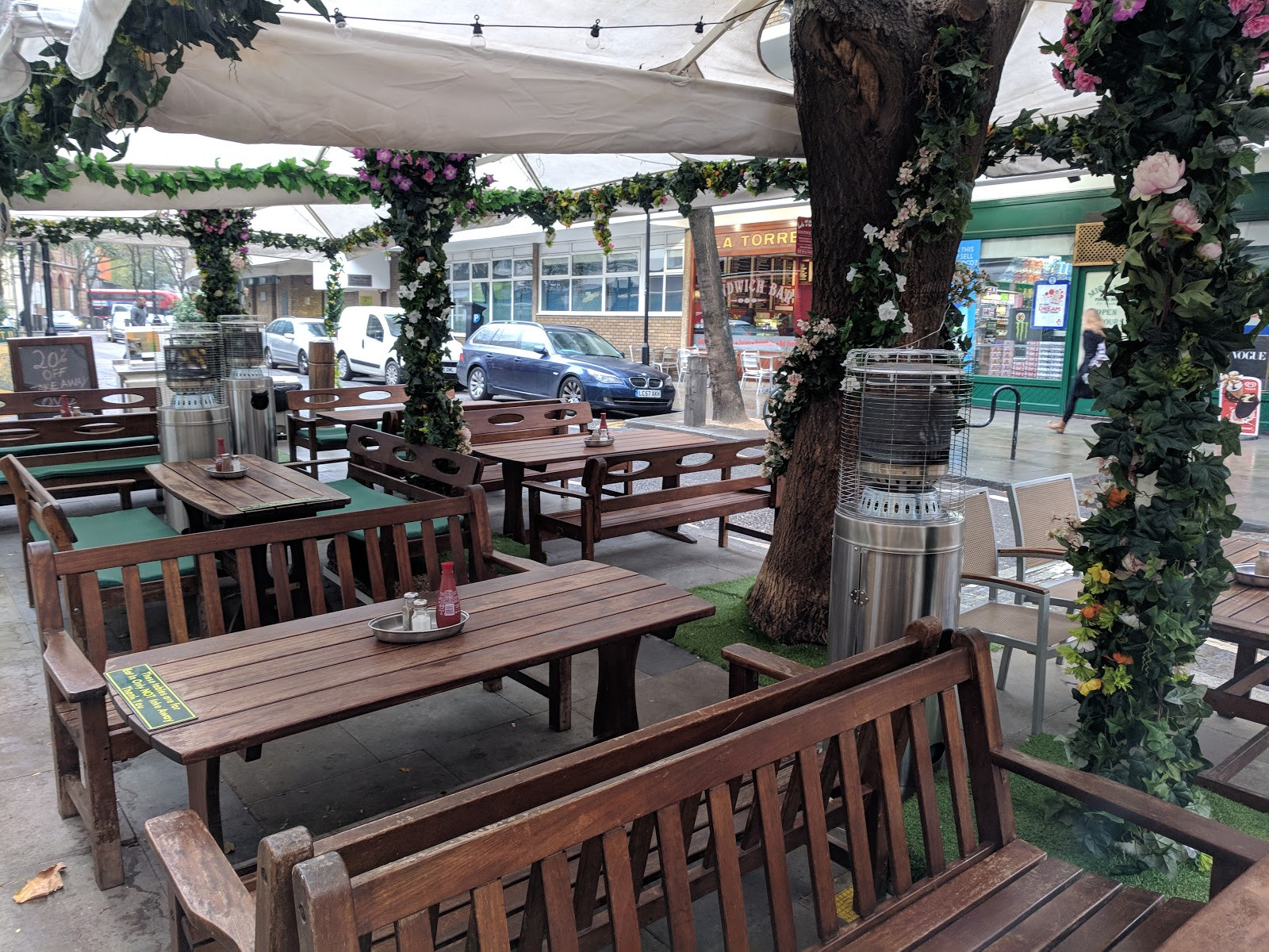 Outdoor seating area at Rock and Sole Plaice London with space heaters.