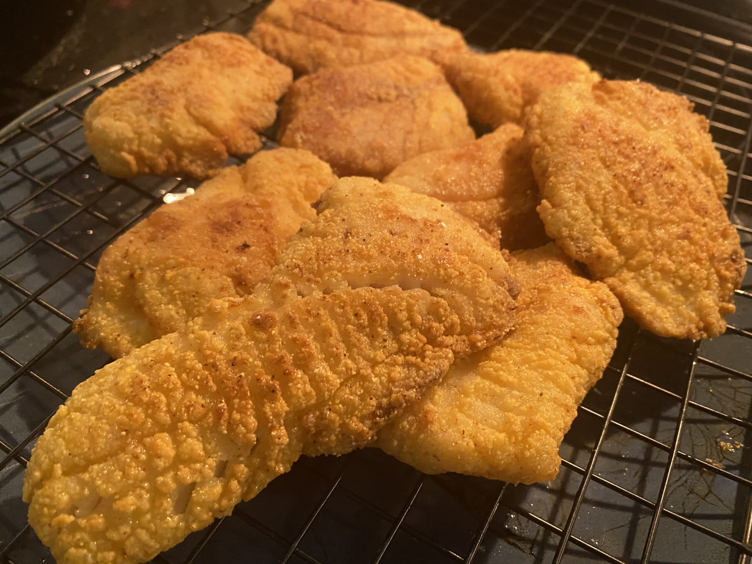 Platter of golden brown Southern fried rock fish, ready to serve.