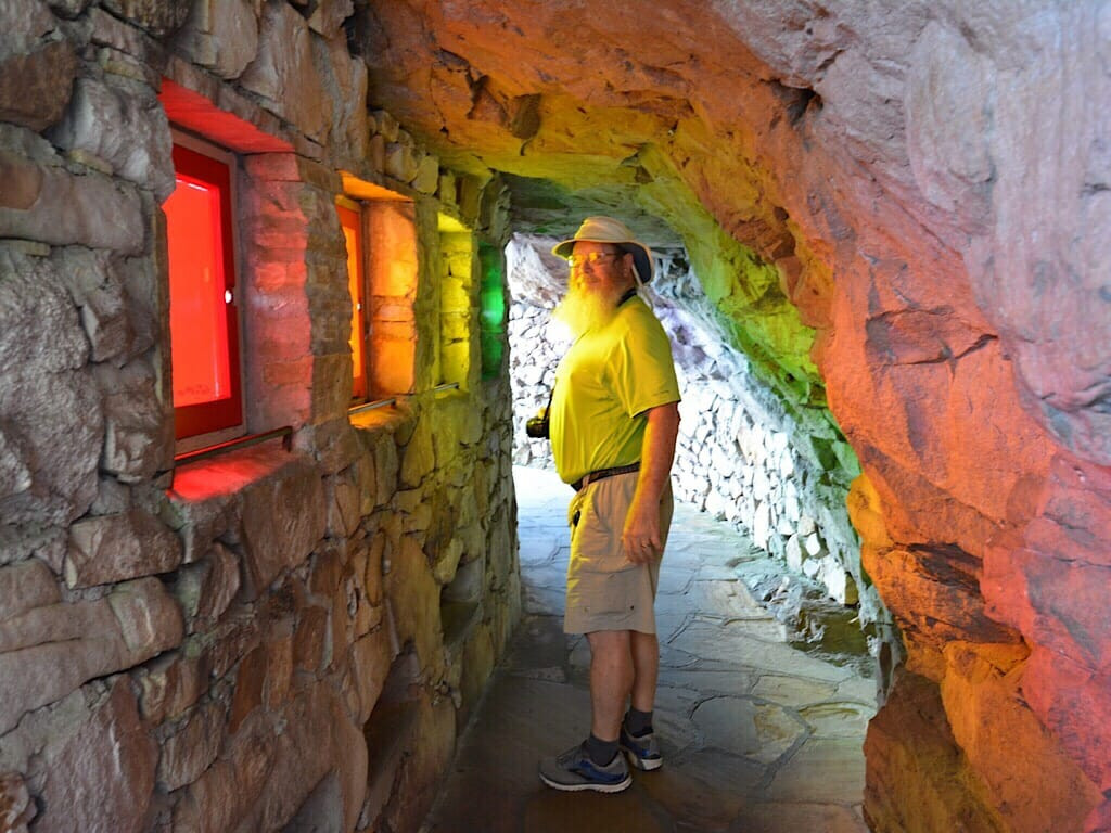 Rainbow Tunnel at Rock City, showcasing the artistic use of light and color within the natural rock formations