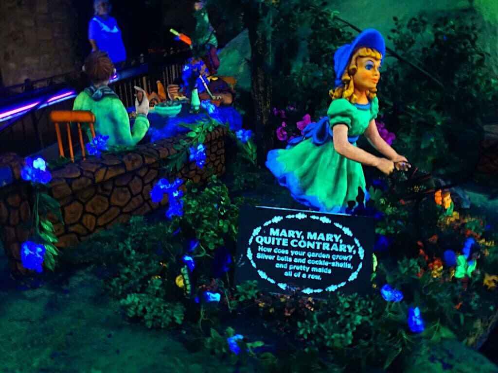 Mother Goose Village in Fairyland Caverns at Rock City, displaying nursery rhyme scenes with vibrant colors and sculptures