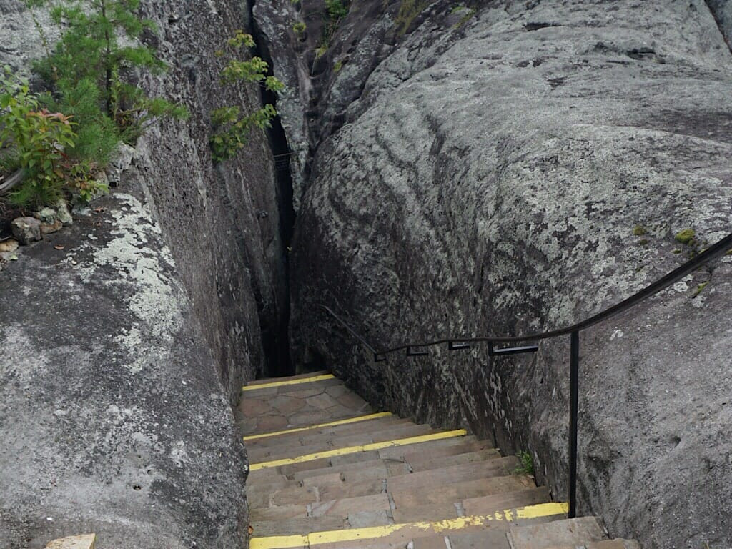 The narrow Fat Man's Squeeze passage requiring visitors to carefully navigate through the rocks