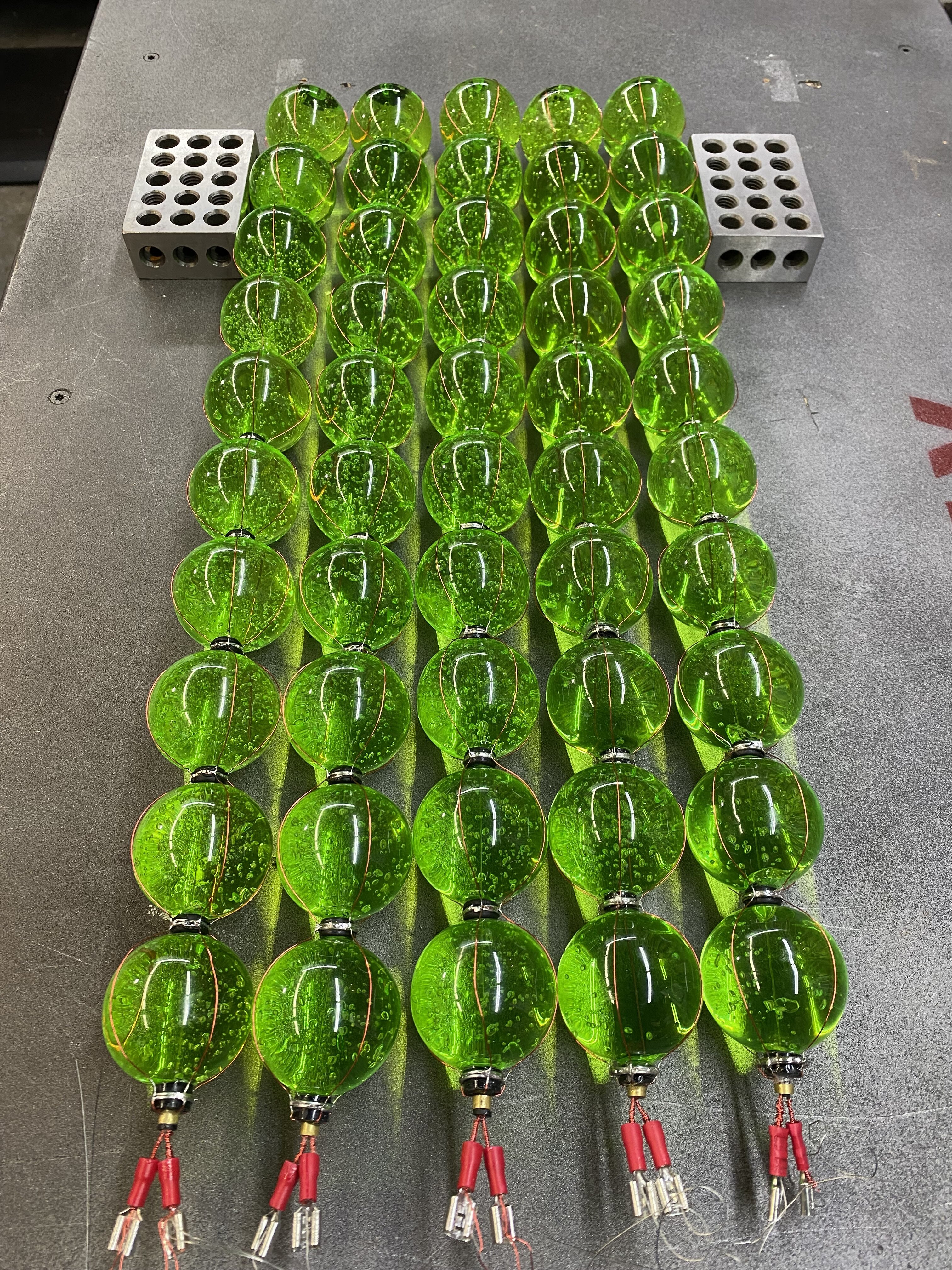 Assembled string of pearls for VX canister prop, showcasing intricate wiring and green vials