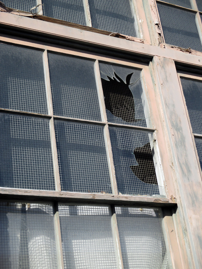 The exterior of the Roebling Wire Works building, the venue for the Punk Rock Flea Market, with broken windows.