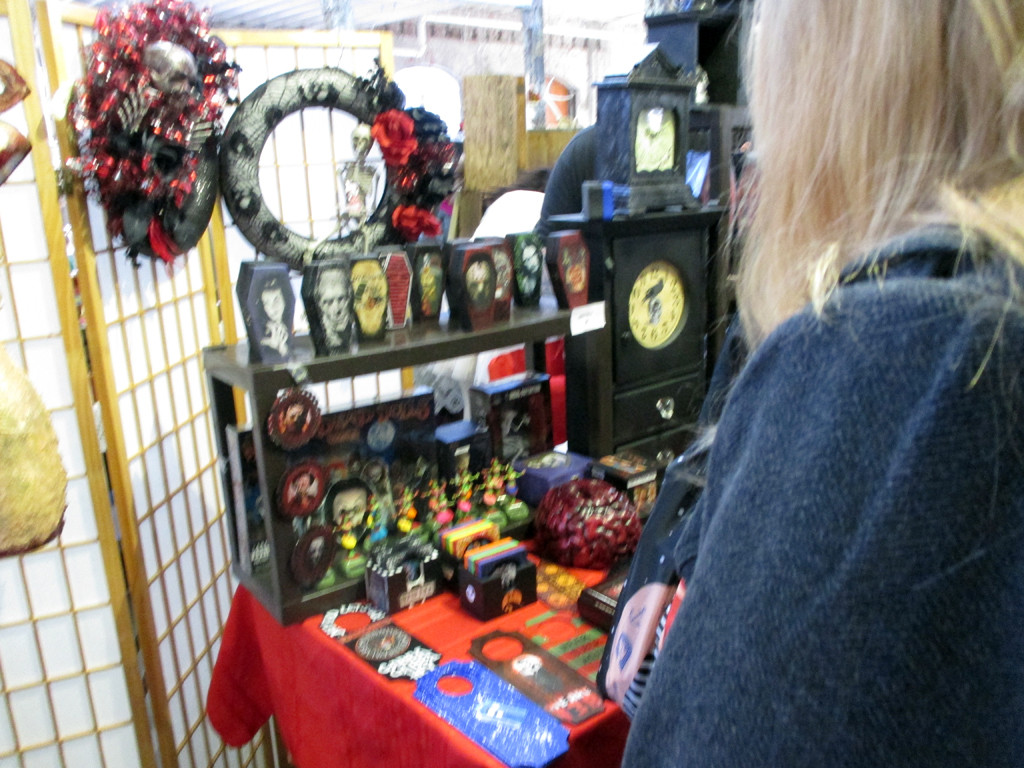 A vendor stall at the Punk Rock Flea Market selling hand-painted mini-coffins with punk rock themes.