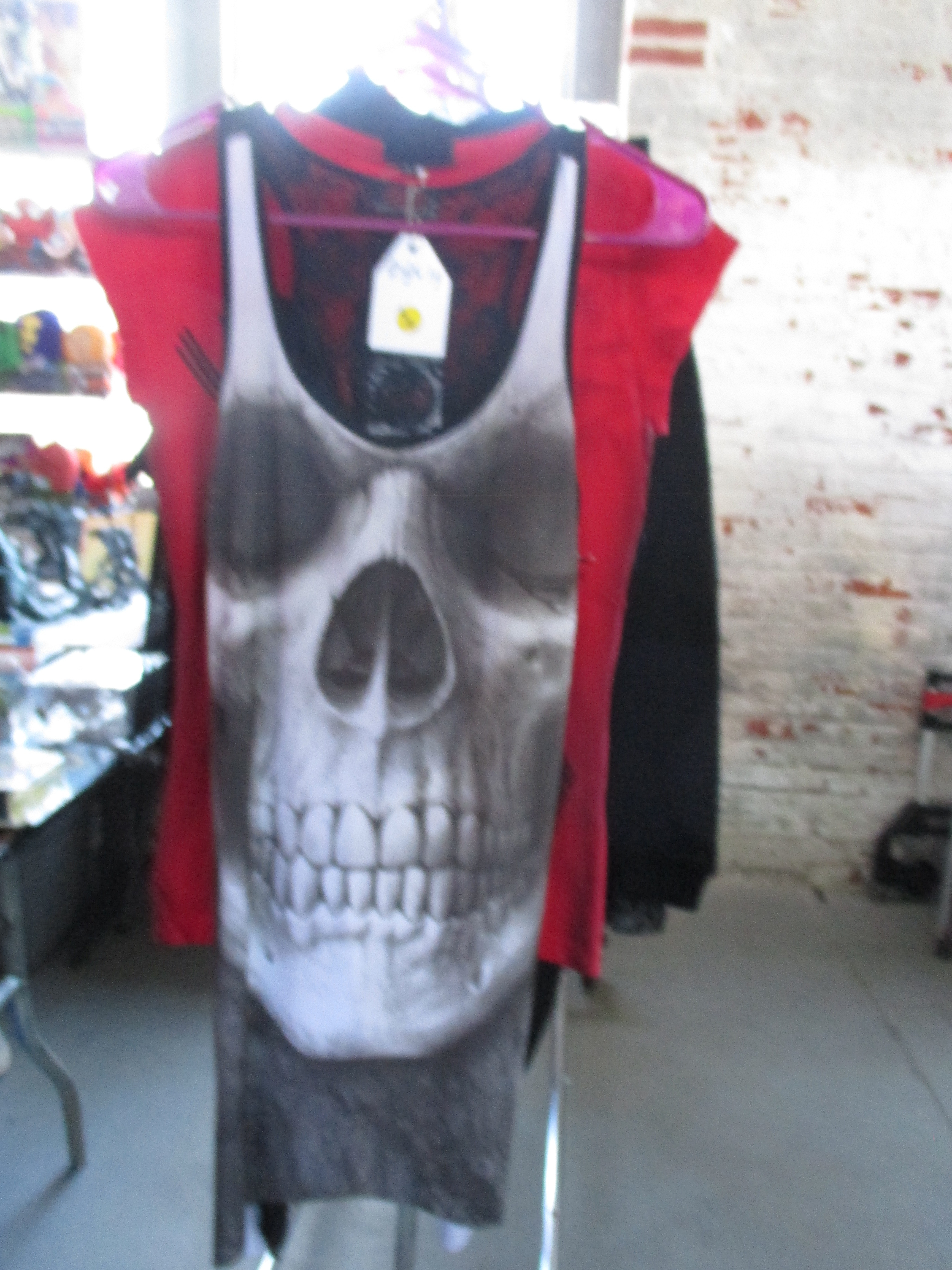 A display of punk rock themed clothing and accessories, including a studded jacket with a skull design.