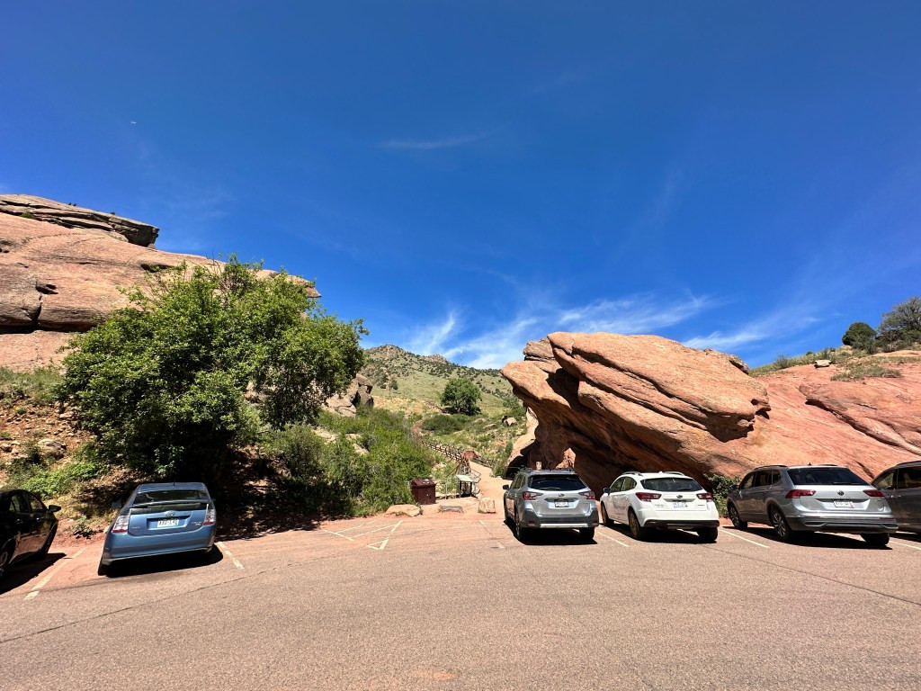 The spacious Half Moon parking lot offering ample parking with a trail leading into the natural landscape.