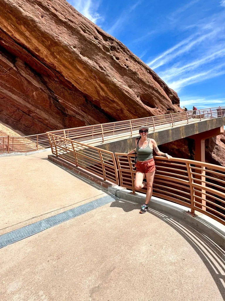 The author leaning against a railing at Red Rocks Amphitheater, highlighting the need for sun protection even at higher altitudes.