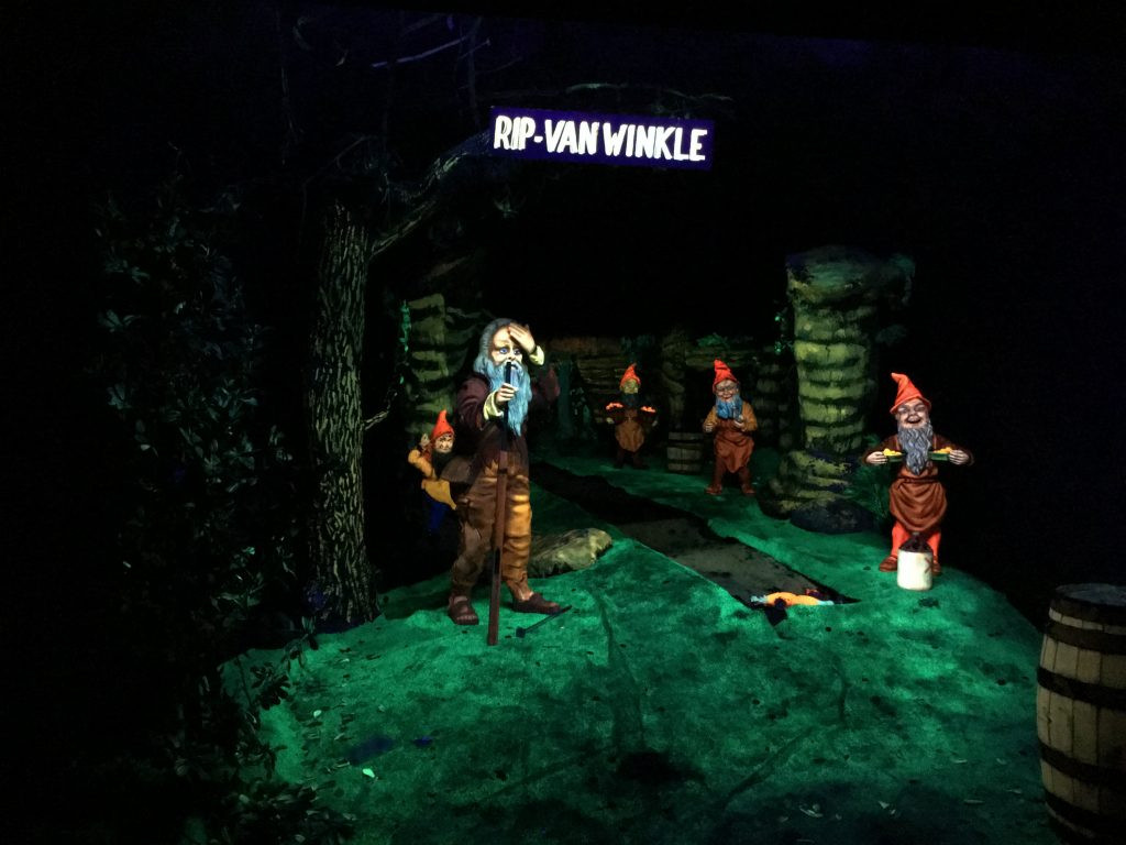 A blacklight display of gnomes in Fairyland Caverns at Rock City.