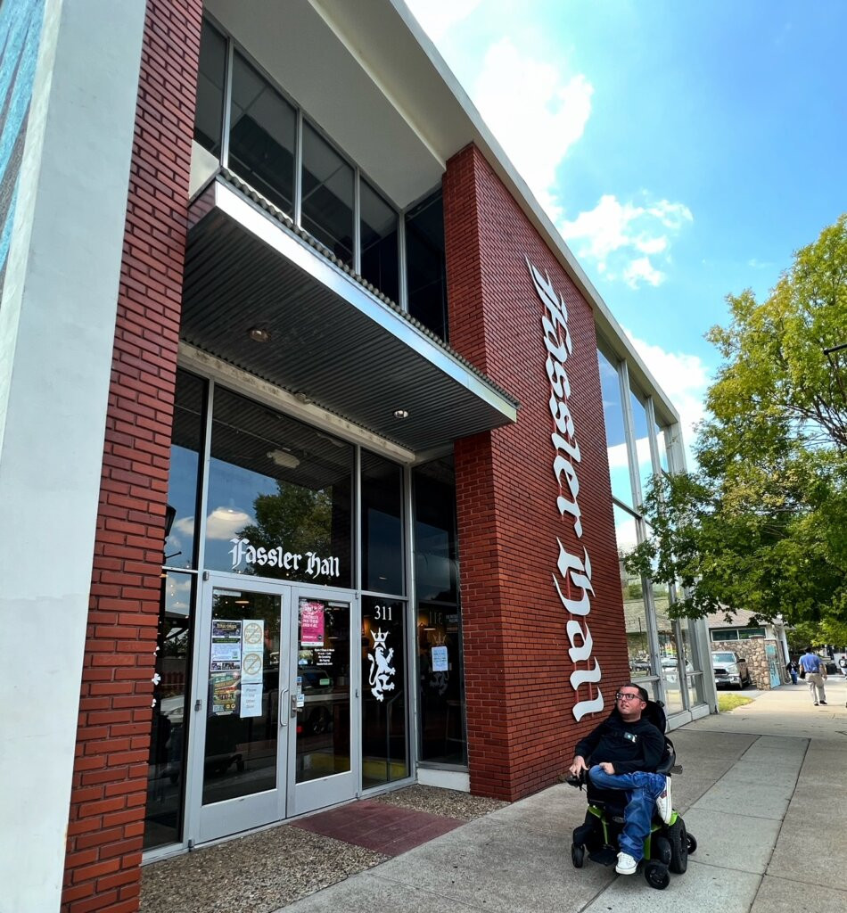 Wheelchair user at a picnic table outside Fassler Hall in Little Rock, Arkansas