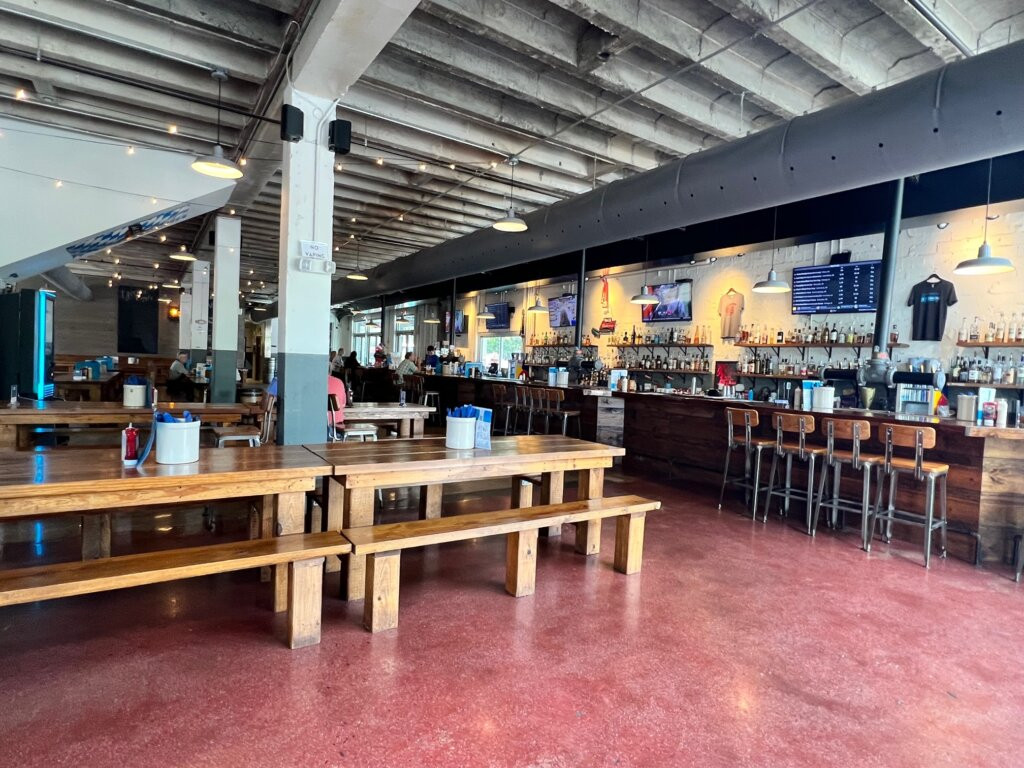 Close up of a wheelchair user's hand holding a Bavarian pretzel at Fassler Hall in Little Rock, Arkansas