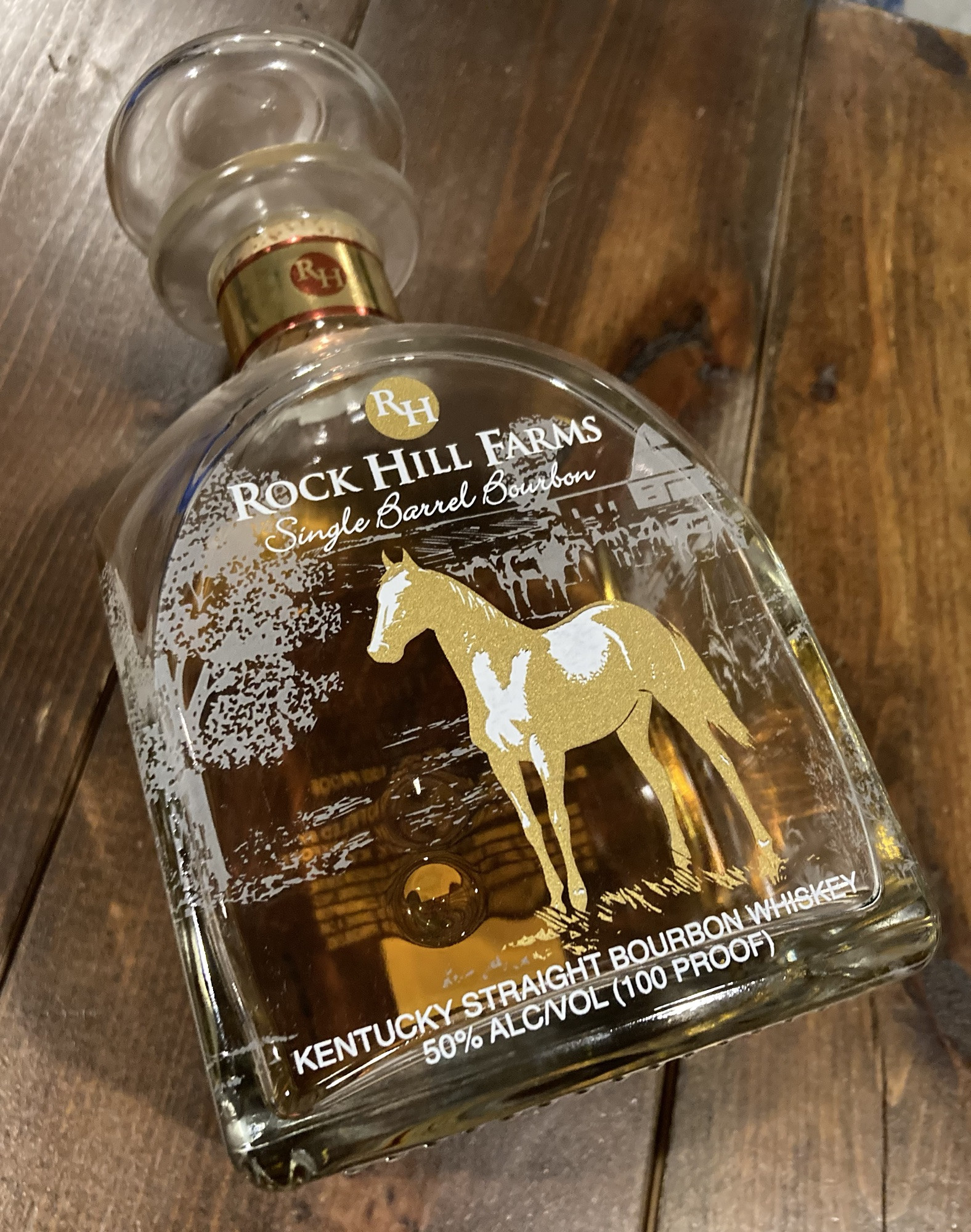 Rock Hill Farms bourbon bottle with a dark background showcasing its label