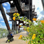 Wheelchair user smiling in front of the Clinton Presidential Center in Little Rock, Arkansas