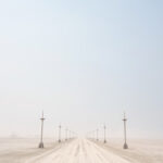 Dusty skies over Black Rock City, Nevada, during Burning Man setup, hinting at the dry desert environment that quickly resolved the bug infestation.