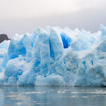 A stunning glacier landscape under a cloudy sky, showcasing the vastness and beauty of glacial ice.