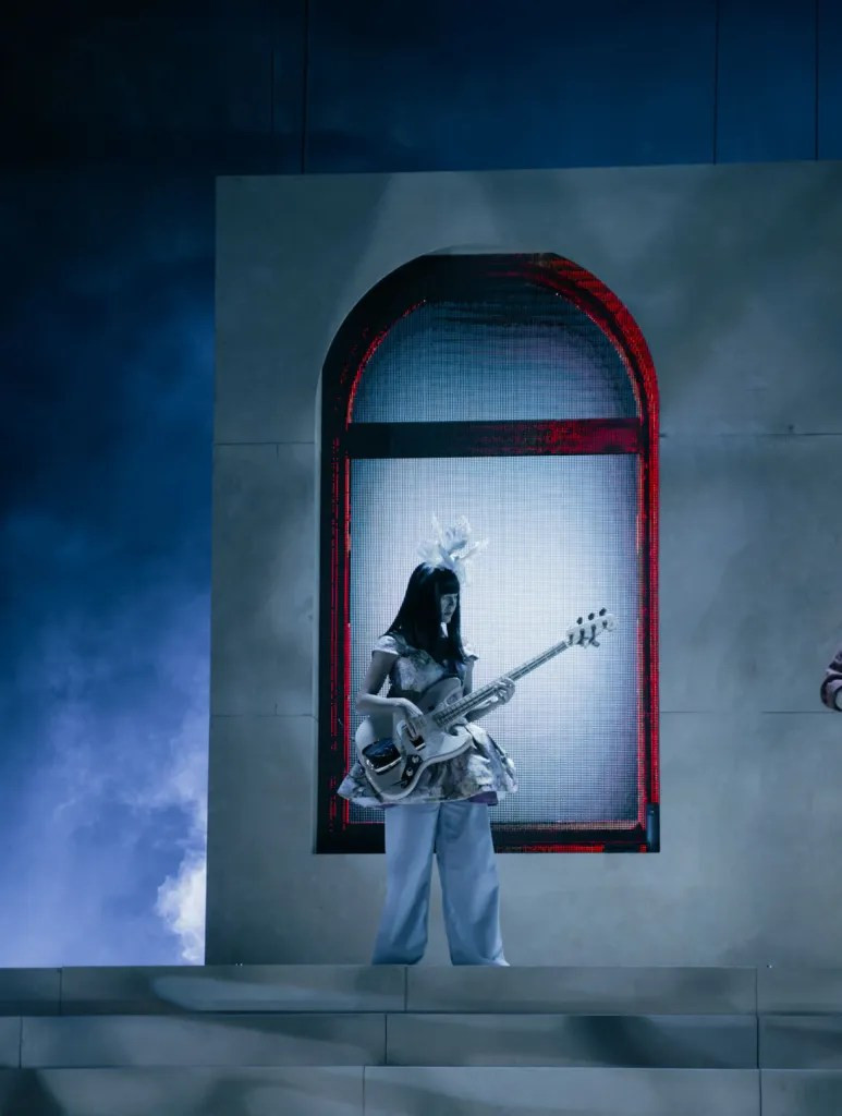 Laura Lee of Khruangbin in close-up, deeply immersed in her bass playing at Red Rocks Amphitheatre.