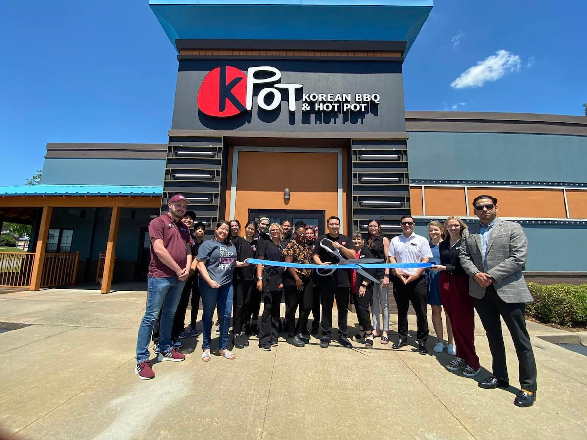 Ribbon cutting ceremony at KPOT Korean BBQ & Hot Pot North Little Rock grand opening