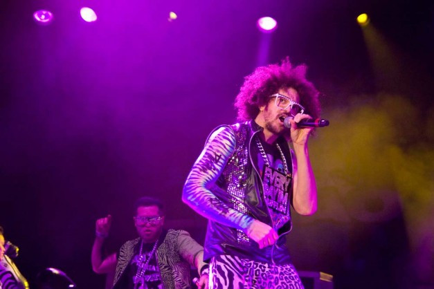 LMFAO, Redfoo and SkyBlu, in their signature quirky outfits, embody the 'party rocking' image that critics found inauthentic.