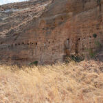 Series of circular rock-cut niches at Teniky, Madagascar, showcasing the unique rock-cut architecture discovered at the site.