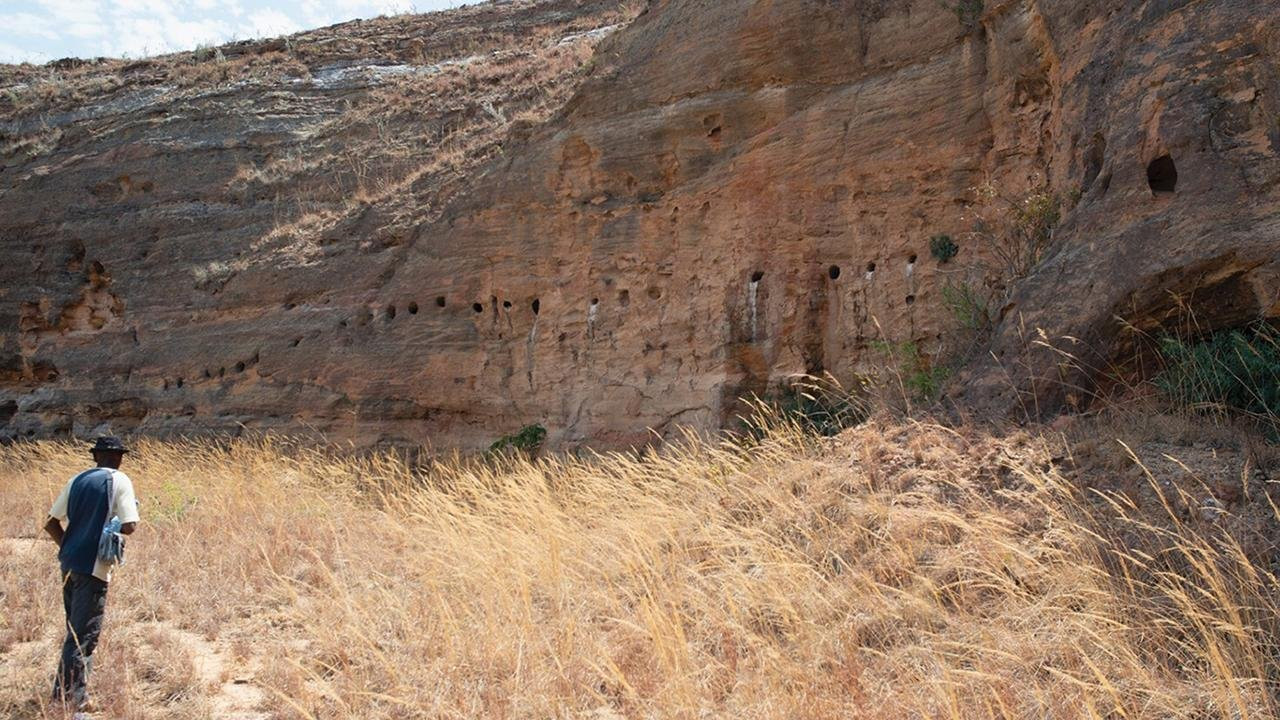 Series of circular rock-cut niches at Teniky, Madagascar, showcasing the unique rock-cut architecture discovered at the site.