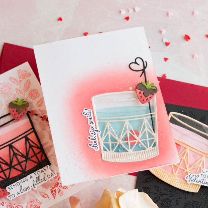 Elegant Valentine's Day cards with embossed floral background and gold tumblers filled with pink hearts, from the Love On The Rocks collection.