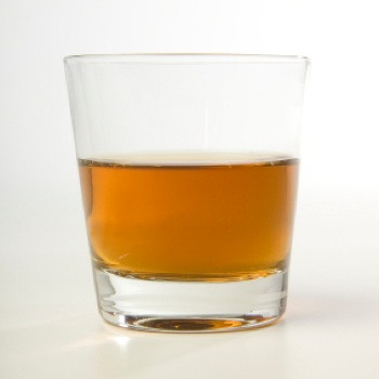 Whiskey on the rocks glass with ice cubes