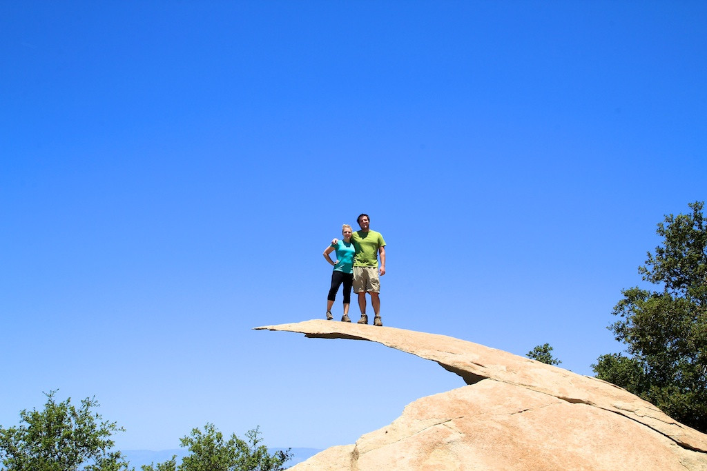 Brave individual standing on Potato Chip Rock, experiencing the thrilling and slightly precarious feeling of being on this thin, projecting rock.