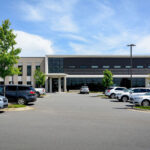 Front view of the UAMS Health Orthopaedic & Spine Clinic in North Little Rock, showcasing the modern facility before the installation of official signage.