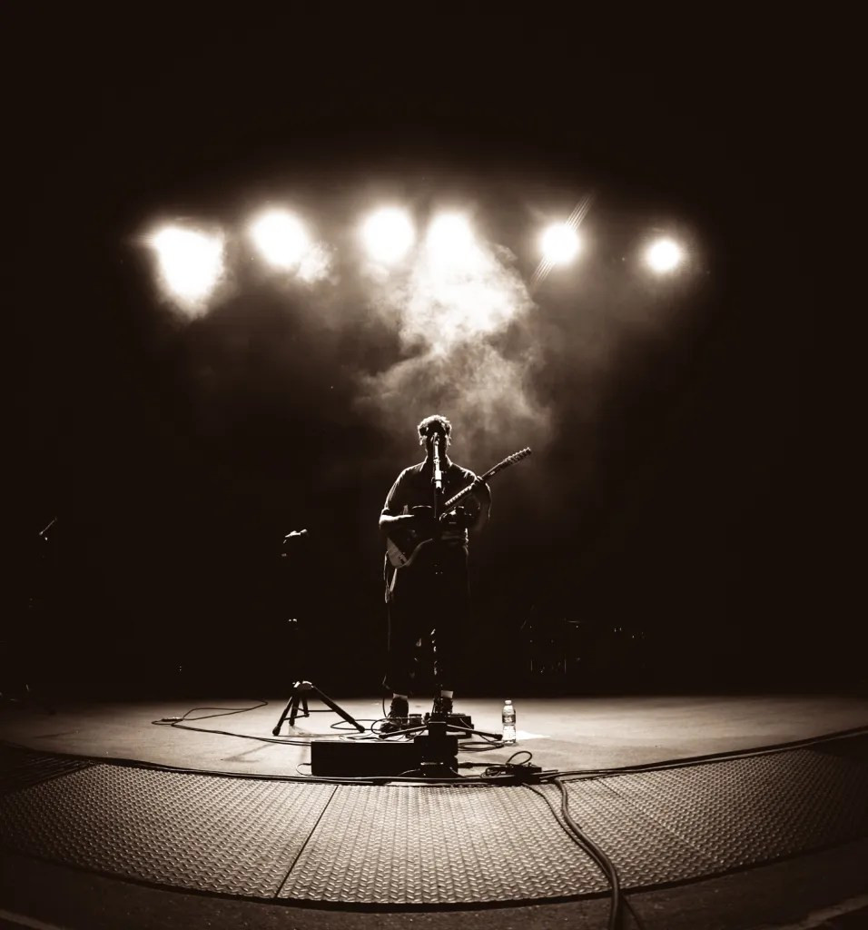 Peter Cat Recording Co. in full swing on the Red Rocks stage, with a backdrop of the iconic red rocks.