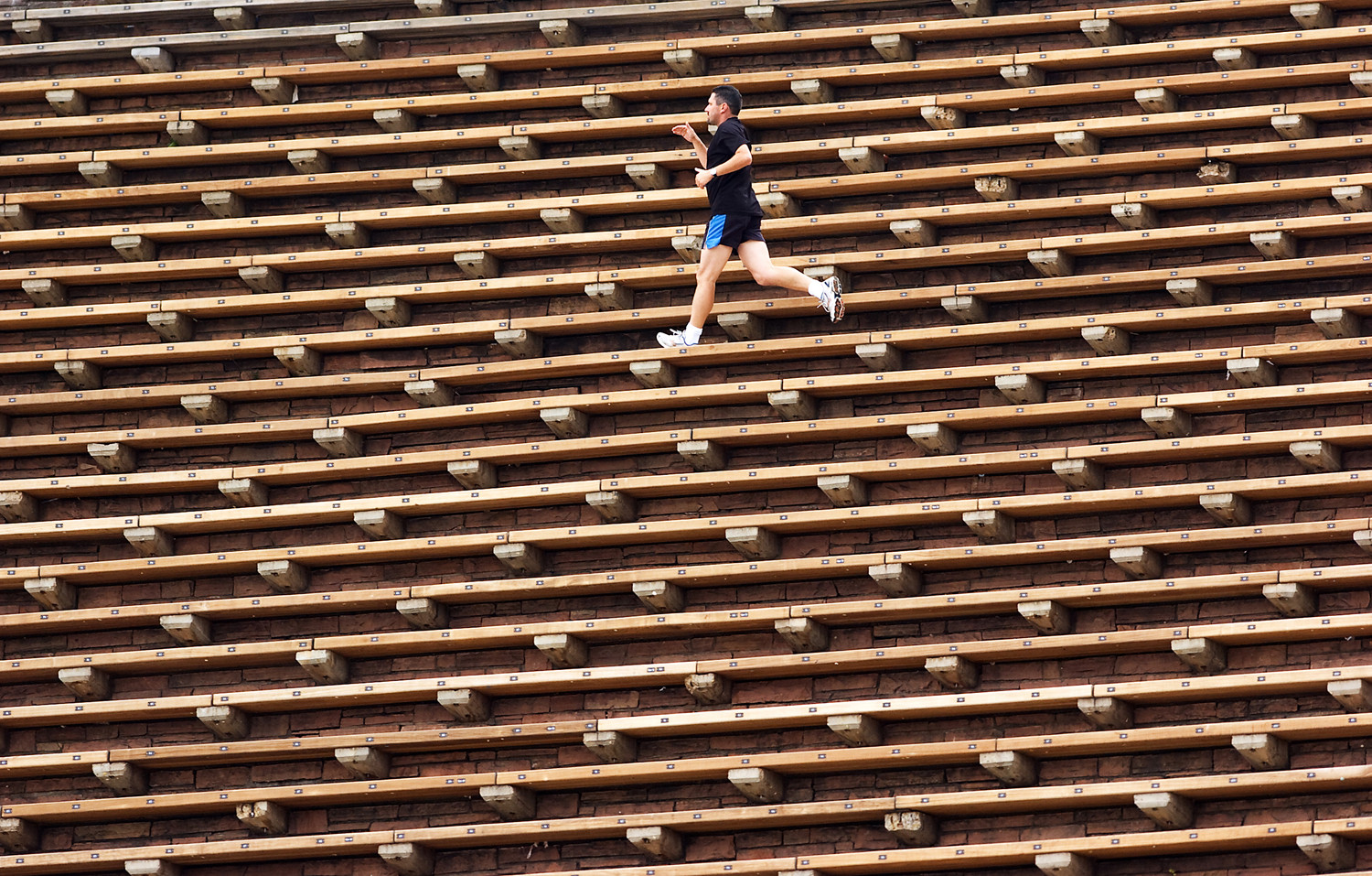 Man Running on Red Rocks Benches: Illustrates the benches as part of a running workout, emphasizing the park's fitness appeal.