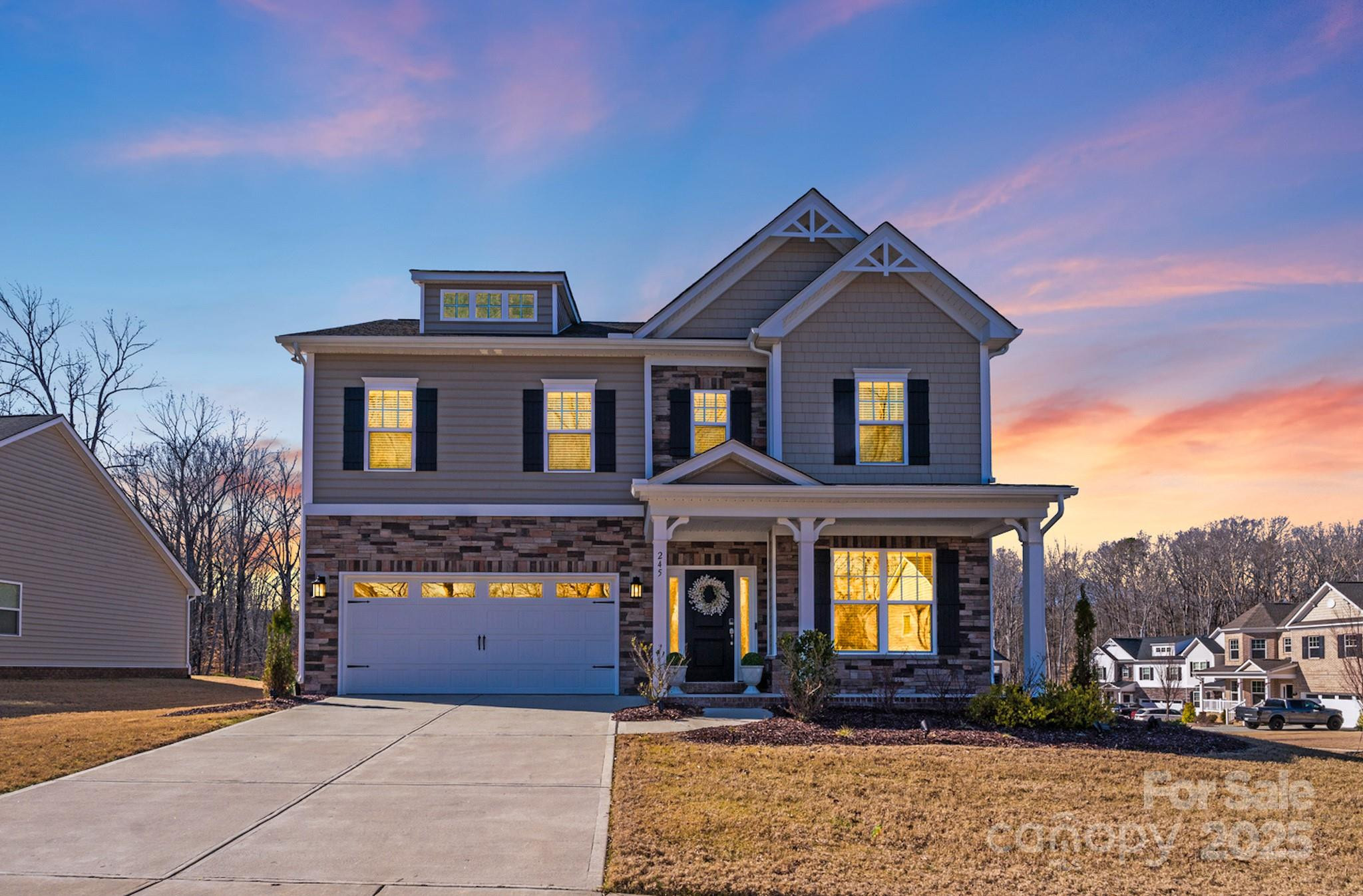 Front facade of a brick house with white trim, a well-manicured lawn, and mature trees, showcasing a classic example of houses for sale in Rock Hill SC neighborhoods.