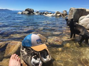 Relaxing at Hidden Beach after hiking to Monkey Rock, Lake Tahoe, enjoying the clear waters and natural beauty.