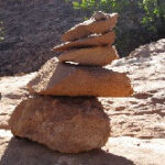 Cairn marking the Balanced Rock trail in Arches National Park, essential for navigation in the desert landscape.