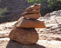 Cairn marking the Balanced Rock trail in Arches National Park, essential for navigation in the desert landscape.