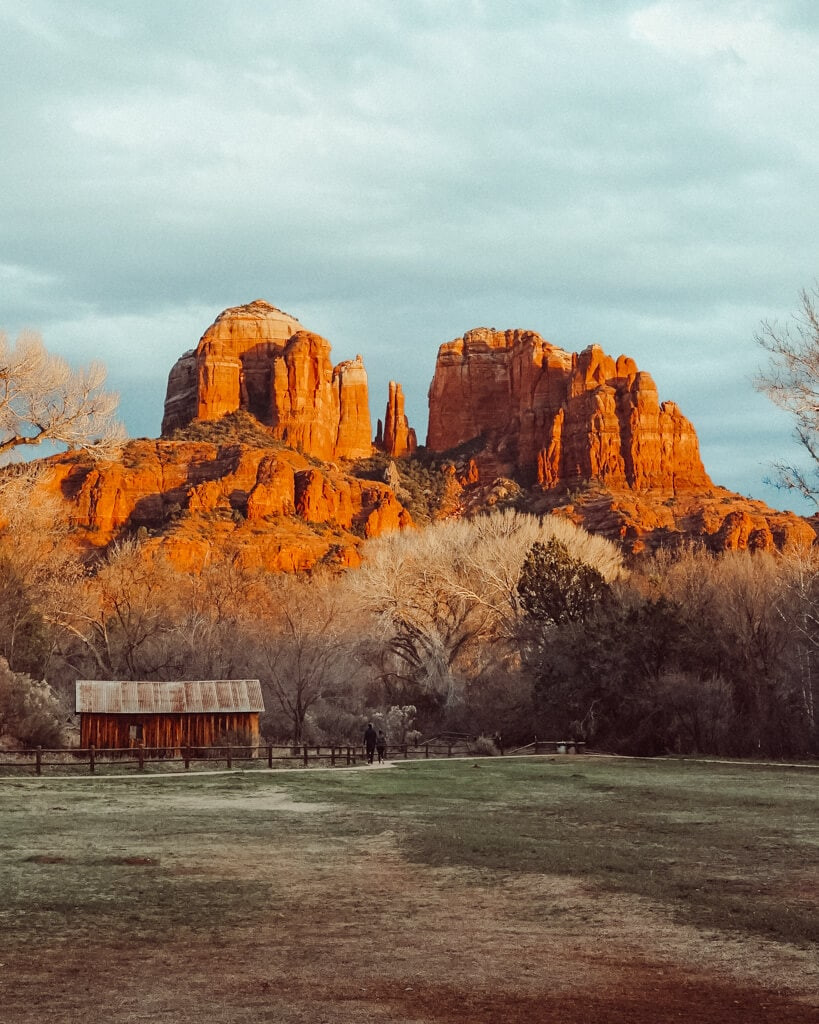 A serene scene from Crescent Moon Picnic Site at sunset, Red Rock Crossing, Sedona, with the red rocks glowing in the evening light.