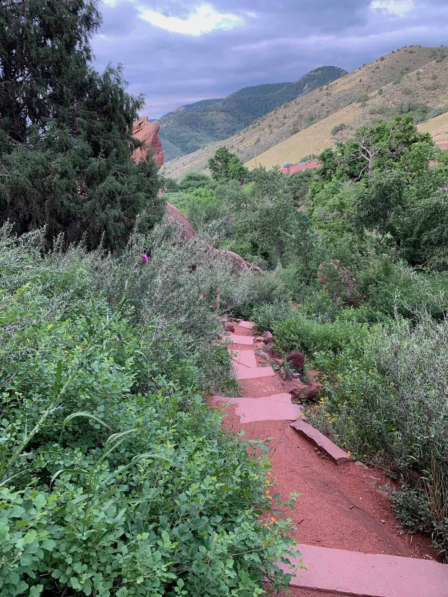 Red rock formations towering over the Trading Post Trail in Red Rocks Park