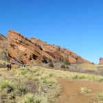 Scenic viewpoint along the Trading Post Trail, showcasing vast red rock formations and natural vegetation.