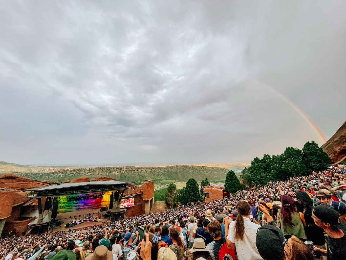 A vibrant rainbow stretching over Red Rocks Amphitheatre after a rain shower